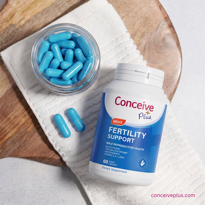 Fertility support supplement with blue capsules on a wooden surface